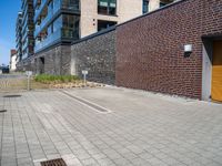 a brick building with a parking lot in front of it and an opening door behind it