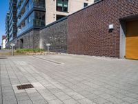 a brick building with a parking lot in front of it and an opening door behind it