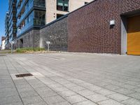 a brick building with a parking lot in front of it and an opening door behind it