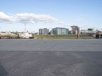 a large body of water with a building in the background, and another bridge crossing the street