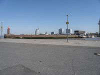 a city skyline on the waterfront is in the distance and two buildings line it's left