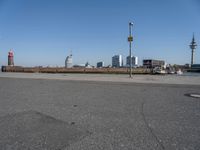 a city skyline on the waterfront is in the distance and two buildings line it's left