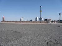 a city skyline on the waterfront is in the distance and two buildings line it's left