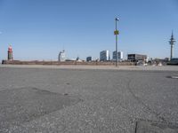 a city skyline on the waterfront is in the distance and two buildings line it's left