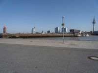 a city skyline on the waterfront is in the distance and two buildings line it's left