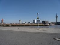 a city skyline on the waterfront is in the distance and two buildings line it's left