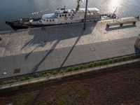 a small ship on the water with flags flying above it as seen from the air