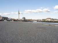 the river that is running through the city by the buildings on the side of the river is next to a road