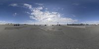 a large wide angle panoramic picture of a skateboarder taking a jump