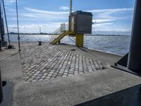 the pier area at a ferry dock with water and a stair on it in front of the water