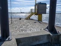 the pier area at a ferry dock with water and a stair on it in front of the water