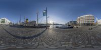 the street has several old ship boats sitting in it and on display together, in circularly