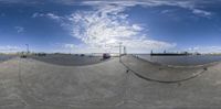 a fish eye picture looking at a street with cars on the side of the road