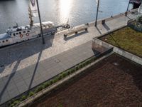 a ship on the water at a marina with several grass on it's roof