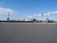 the skyline is in the background from the street where the water meets the shoreline of a river