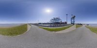 a picture from a 360 - degree fish eye lens with the view of the beach