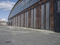 a side alley with brick walls, windows and parking lot at a business district with people walking in