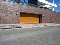 a red fire hydrant in front of a brick building with orange garage doors in front