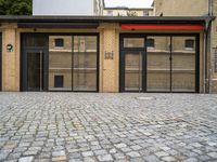 an empty building with a small doorway between it and some brick bricks on the ground