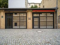 an empty building with a small doorway between it and some brick bricks on the ground