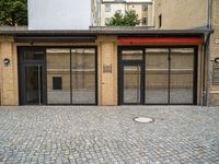 an empty building with a small doorway between it and some brick bricks on the ground