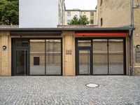 an empty building with a small doorway between it and some brick bricks on the ground