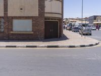 a building with the sign that reads to the right of the road is a closed street, with a yellow line on the road in front of it, and some buildings