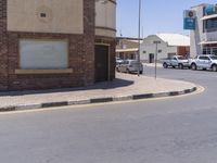 a building with the sign that reads to the right of the road is a closed street, with a yellow line on the road in front of it, and some buildings