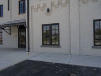 a brick building with a parking meter and a fire hydrant in front of it