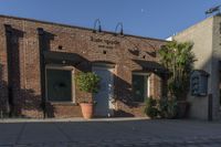 there is a building with many potted plants on it's sides, as well as a window