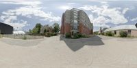 a large circular panorama of an urban area with brick buildings and a sky background with a big building