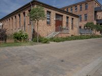 the street is lined with bricks near buildings and trees in front of it for people to walk