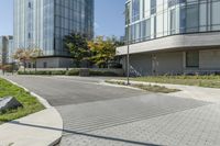 a brick sidewalk with an empty parking space in front of it at an outdoor office building