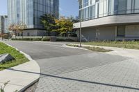 a brick sidewalk with an empty parking space in front of it at an outdoor office building