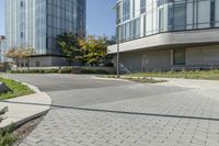 a brick sidewalk with an empty parking space in front of it at an outdoor office building