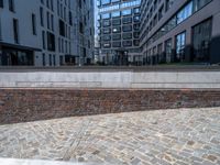 the brick sidewalk in front of two buildings has a few bricks on it near it