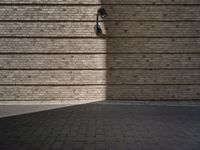 a brick sidewalk and an outside area with a wall of bricks and a street light