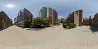 360 - degree photo of brick streets and buildings on the outside of them in a city