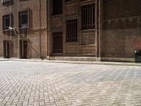 two bicycles are parked outside of an old building in front of each other in the day