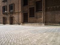 two bicycles are parked outside of an old building in front of each other in the day