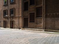 two bicycles are parked outside of an old building in front of each other in the day