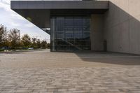 the brick walkway outside a large building is pictured in this photo, it appears to be in motion