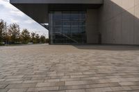 the brick walkway outside a large building is pictured in this photo, it appears to be in motion