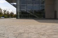 the brick walkway outside a large building is pictured in this photo, it appears to be in motion