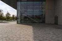 the brick walkway outside a large building is pictured in this photo, it appears to be in motion