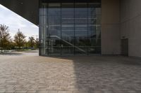 the brick walkway outside a large building is pictured in this photo, it appears to be in motion