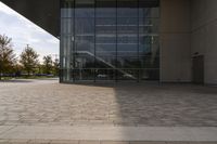 the brick walkway outside a large building is pictured in this photo, it appears to be in motion