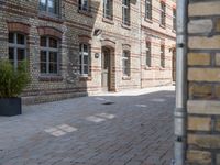 this brick walkway features a stone brick wall and tree lined building with a blue sign stating to have closed all year