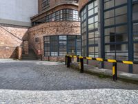 an empty parking area next to the sidewalk near buildings with signs on it that say