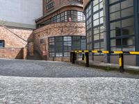 an empty parking area next to the sidewalk near buildings with signs on it that say